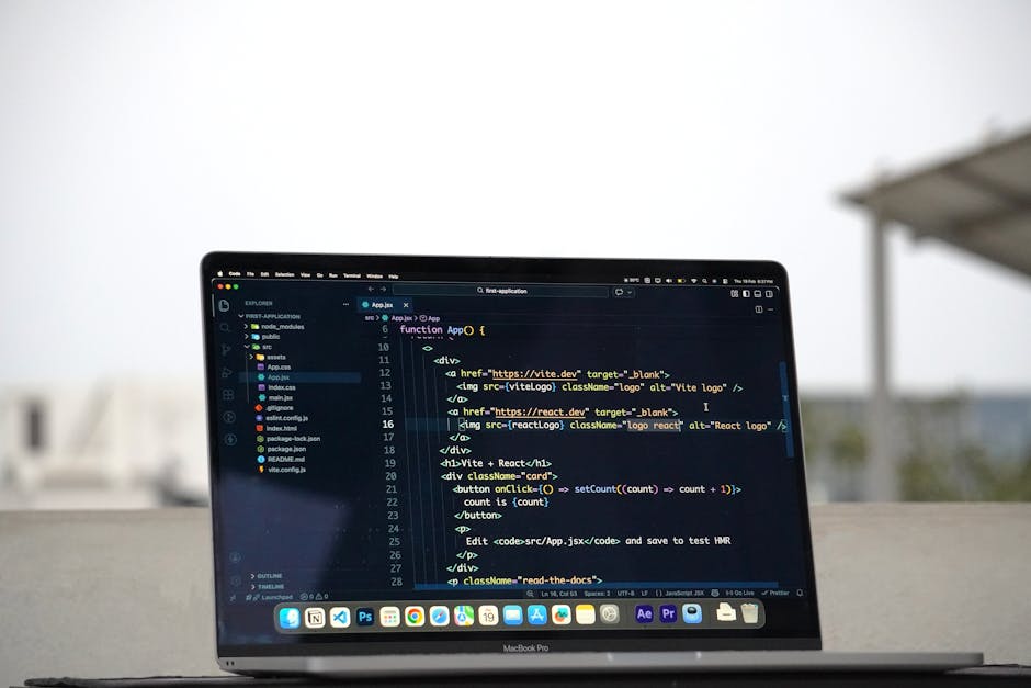 A close-up view of a laptop computer screen displaying lines of code in a dark-themed code editor with syntax highlighting in various colors. The code appears to be related to a web application, with